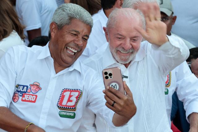 Brazil's President and presidential candidate Luiz Inacio Lula da Silva (R) and the governor of Bahia Jeronimo Rodrigues pose for a selfie during a campaign rally in Salvador, Bahia state, Brazil on September 29, 2026. Brazil will hold presidential election on October 4, 2026. (Photo by ANTONELLO VENERI / AFP)