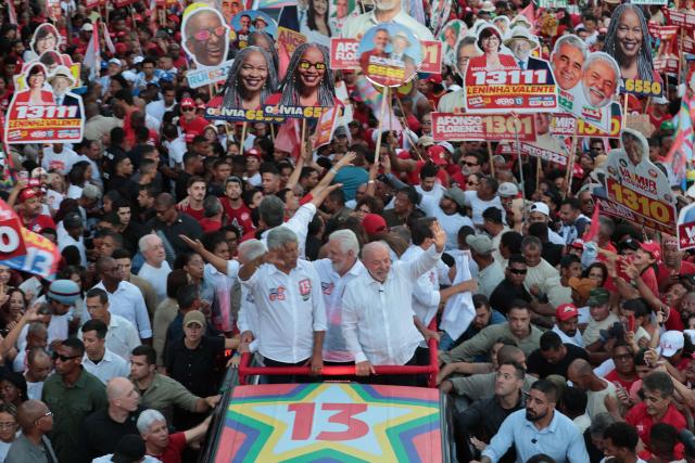 Brazil's President and presidential candidate Luiz Inacio Lula da Silva (R) and the governor of Bahia Jeronimo Rodrigues wave during a campaign rally in Salvador, Bahia state, Brazil on September 29, 2026. Brazil will hold presidential election on October 4, 2026. (Photo by ANTONELLO VENERI / AFP)