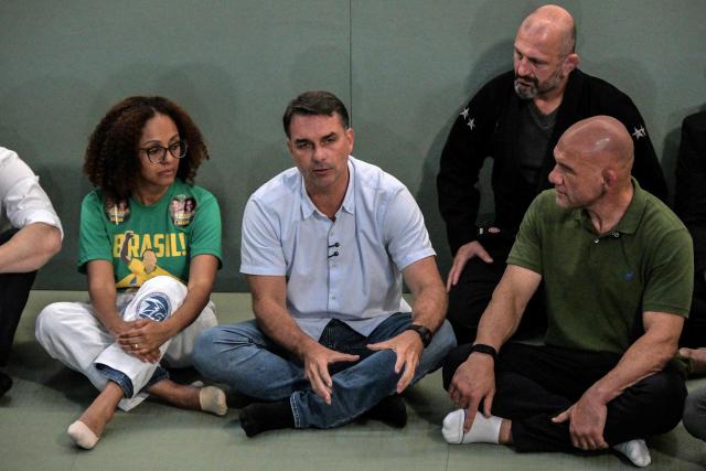 Brazil's right-wing senator and presidential candidate Flavio Bolsonaro (C) of the Liberal Party (PL) meets with jiu-jitsu practitioners at a gym during a campaign rally in Sao Paulo, Brazil, on September 29, 2026. Brazil will hold presidential election on October 4, 2026. (Photo by Nelson ALMEIDA / AFP)