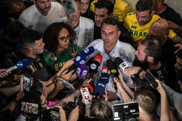 Brazil's right-wing senator and presidential candidate Flavio Bolsonaro of the Liberal Party (PL) speaks with journalists after meeting with jiu-jitsu practitioners at a gym during a campaign rally in Sao Paulo, Brazil, on September 29, 2026. Brazil will hold presidential election on October 4, 2026. (Photo by Nelson ALMEIDA / AFP)