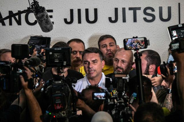 Brazil's right-wing senator and presidential candidate Flavio Bolsonaro of the Liberal Party (PL) speaks with journalists after meeting with jiu-jitsu practitioners at a gym during a campaign rally in Sao Paulo, Brazil, on September 29, 2026. Brazil will hold presidential election on October 4, 2026. (Photo by Nelson ALMEIDA / AFP)