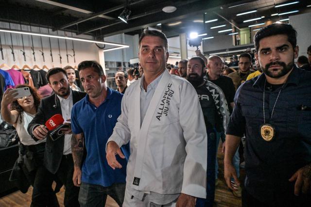Brazil's right-wing senator and presidential candidate Flavio Bolsonaro (C) of the Liberal Party (PL) leaves a gym after meeting with jiu-jitsu practitioners during a campaign rally in Sao Paulo, Brazil, on September 29, 2026. Brazil will hold presidential election on October 4, 2026. (Photo by Nelson ALMEIDA / AFP)