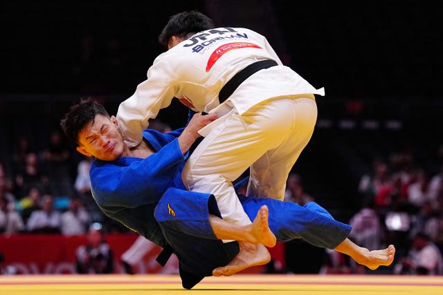 China's Ma Yulin (blue) and Japan's Kondo Hayato compete in the men's 60kg judo quarterfinals at Aichi International Arena during the 2026 Asian Games in Nagoya on September 30, 2026. (Photo by Yuichi YAMAZAKI / AFP)