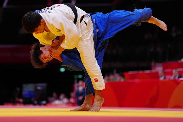 Bahrain's Ruslan Poltoratskii (blue) and Uzbekistan's Samariddin Kuchkarov compete in the men's 60kg judo quarterfinals at Aichi International Arena during the 2026 Asian Games in Nagoya on September 30, 2026. (Photo by Yuichi YAMAZAKI / AFP)