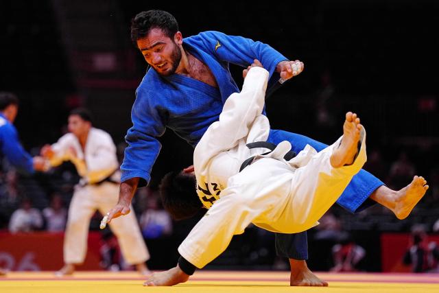 Kazakhstan's Gusman Kyrgyzbayev (blue) and Bahrain's Sukhrob Boqiev compete in the men's 66kg judo quarterfinals at Aichi International Arena during the 2026 Asian Games in Nagoya on September 30, 2026. (Photo by Yuichi YAMAZAKI / AFP)