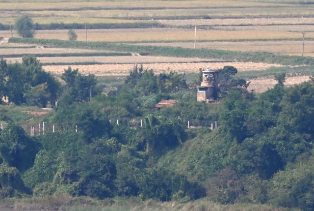 A North Korean guard post and military fences on the North side of the Demilitarised Zone (DMZ) dividing the two Koreas, are seen from a South Korean observatory in Paju on September 30, 2026. Seoul's military demanded an apology from North Korea on September 30, blaming them for a recent explosion in the demilitarised zone that severely injured three South Korean soldiers, a charge Pyongyang denies. (Photo by Jung Yeon-je / AFP)