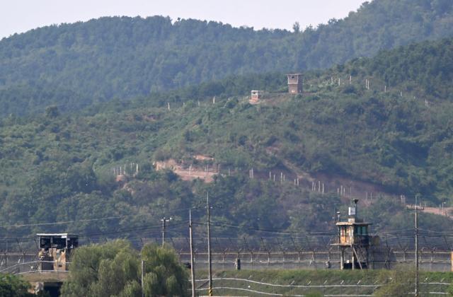 A North Korean guard post (top) on the North side of the Demilitarised Zone (DMZ) dividing the two Koreas, is seen over a South Korean guard post (bottom) from the border city of Paju on September 30, 2026. Seoul's military demanded an apology from North Korea on September 30, blaming them for a recent explosion in the demilitarised zone that severely injured three South Korean soldiers, a charge Pyongyang denies. (Photo by Jung Yeon-je / AFP)