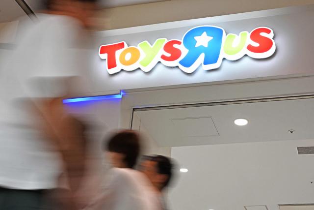 Shoppers walk near a ToysRus store in Tokyo on September 30, 2026. (Photo by Toshifumi KITAMURA / AFP)