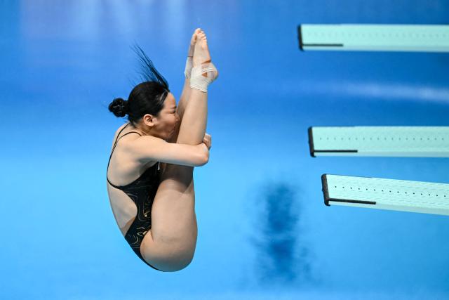 South Korea's Kim Su-ji competes in the women's 3m springboard final diving event during the 2026 Asian Games at the Tokyo Aquatics Centre in Tokyo on September 30, 2026. (Photo by ANDREW CABALLERO-REYNOLDS / AFP)