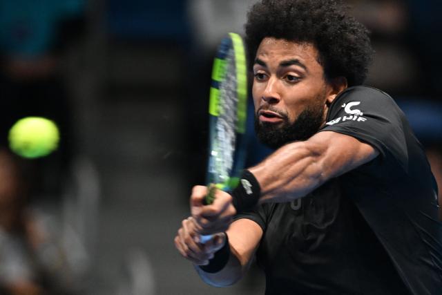 France's Arthur Fils plays a shot to France's Luca van Assche during their men's singles tennis match at the ATP Tour Japan Open Tennis Championships at the Ariake Tennis Forest Park in Tokyo on September 30, 2026. (Photo by Rie KIKUCHI / AFP)