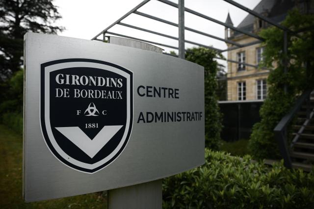 (FILES) This general view taken on May 19, 2022, shows a sign with a logo in front of the chateau of FC Girondins de Bordeaux at the club's training ground in Le Haillan, near Bordeaux, south-western France. A sale agreement between Girondins de Bordeaux—which was administratively relegated to the regional division—and the British investment fund Park Bench was signed on September 30, 2026, the club said, adding that it should thus avoid bankruptcy. (Photo by Philippe LOPEZ / AFP)