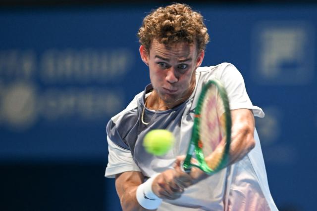 France's Luca van Assche plays a shot to France's Arthur Fils during their men's singles tennis match at the ATP Tour Japan Open Tennis Championships at the Ariake Tennis Forest Park in Tokyo on September 30, 2026. (Photo by Rie KIKUCHI / AFP)