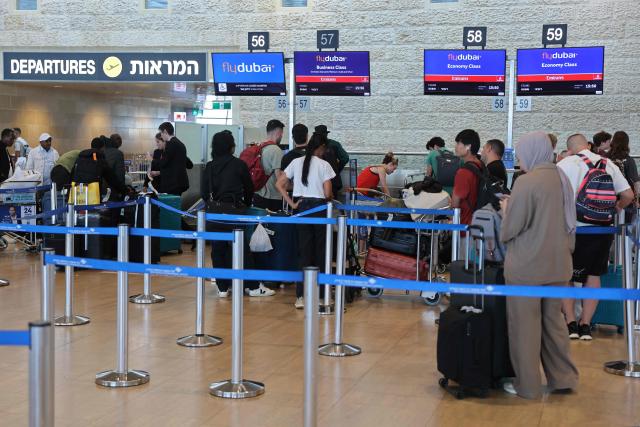 Passengers queue at the flydubai counters in Ben Gurion Airport near Tel Aviv on September 30, 2026. The emergency landing on September 30 of a Tel Aviv-bound flydubai flight was due to a "terrorist" who wanted to crash the plane and kill Israelis, Israel's far-right national security minister said. (Photo by Jack GUEZ / AFP)