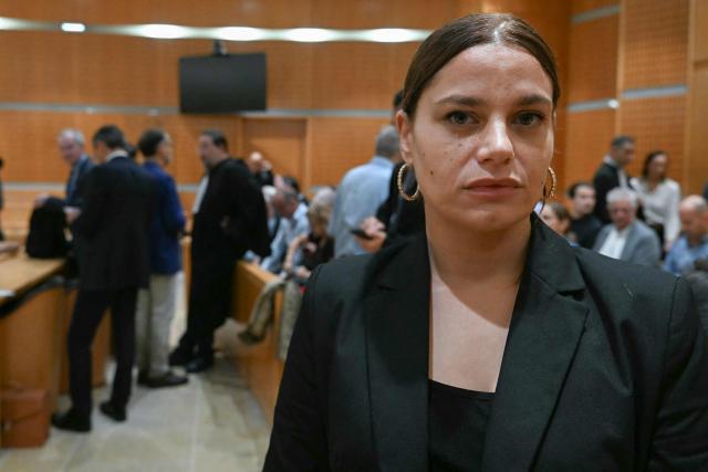 Eva Marty, the French woman whose wedding to an Algerian man was refused by Beziers mayor Robert Menard in 2023, waits at the courthouse in Montpellier, southern France, on September 30, 2026, ahead of the opening of Menard's trial. Menard refused to officiate the wedding because the groom, an Algerian national, was subject to an Obligation to Leave French Territory (OQTF). The couple later married in Algeria. Menard could face up to five years in prison, a fine of 75,000 euros and a ban on standing for election. (Photo by Gabriel BOUYS / AFP)