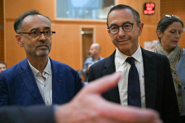 Mayor of Beziers Robert Menard (L) flanked by Right wing party Les Republicains (LR) candidate in France's 2027 presidential election Bruno Retailleau (R) arrives for the opening of his trial after he refused to officiate a wedding in 2023 between a French woman and an Algerian man in irregular situation and subject to an Obligation to leave French territory (OQTF), at the courthouse of Montpellier, southern France, on September 30, 2026. Menard could face up to five years in prison, a fine of 75,000 euros and a ban on standing for election. (Photo by Gabriel BOUYS / AFP)