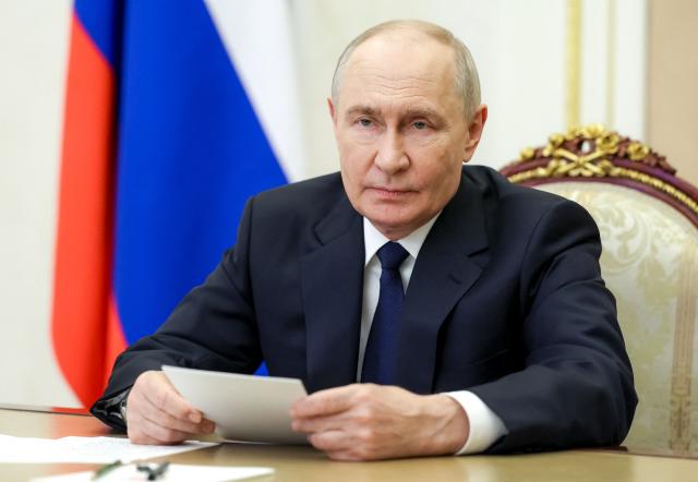 In this pool photograph distributed by the Russian state agency Sputnik, Russia's President Vladimir Putin holds a meeting with newly elected regional governors via video link in Moscow on September 30, 2026. (Photo by Vyacheslav PROKOFYEV / POOL / AFP)