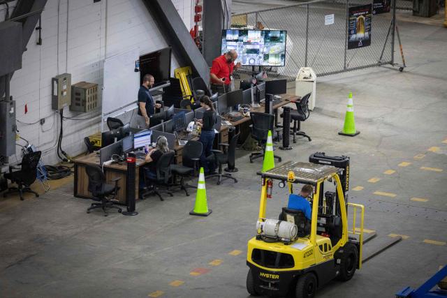Workers are seen inside the Vehicle Assembly Building (VAB) as work continues on booster progression for the Artemis III, at Kennedy Space Center, in Cape Canaveral, Florida, on September 30, 2026. Artemis III is an upcoming crewed mission led by the NASA Artemis program, targeting a 2027 launch. (Photo by Marco BELLO / AFP)