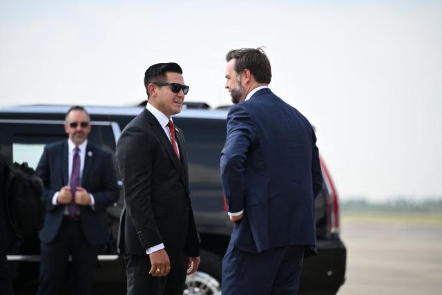 US Vice President JD Vance (R) is greeted by Eric Flores, Republican from Texas and candidate for US House of Representatives, upon arrival in Brownsville, Texas, on September 30, 2026. Vance is in Texas to headline political events and support Republican candidates ahead of the midterm elections. (Photo by Kenny Holston/The New York Times / POOL / AFP)