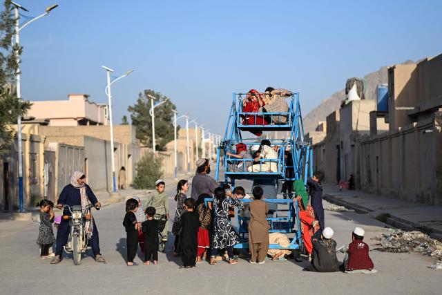 Afghan children ride on a swing in Merwais Mena village in the 7th district of Afghanistan's Kandahar province on September 30, 2026. (Photo by Sanaullah SEIAM / AFP)