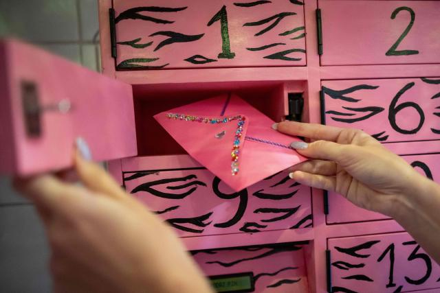 This photo, taken on September 30, 2026, shows an activist taking an envelope containing medication from one of the compartments of the “Abortomat” – Poland’s first-ever abortion locker that allows women to access pregnancy-terminating pills anonymously, at the abortion consultation point “Abotak,” located across the street from the entrance to the Polish parliament in Warsaw. Polish activists have opened the country's first-ever abortion locker, allowing women to access pregnancy-terminating pills anonymously and immediately in the country with some of Europe's strictest abortion laws, an activist told AFP on September 30, 2026. (Photo by Wojtek RADWANSKI / AFP)