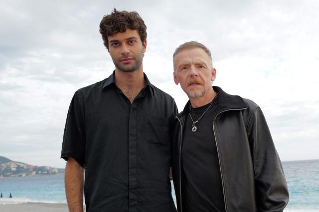 British actor Simon Pegg (R) and French actor Liam Hellmann (L) pose during a photocall  for the movie “Only What We Carry” at the Cineroman film festival in Nice, southeastern France on September 30, 2026. (Photo by Valery HACHE / AFP)
