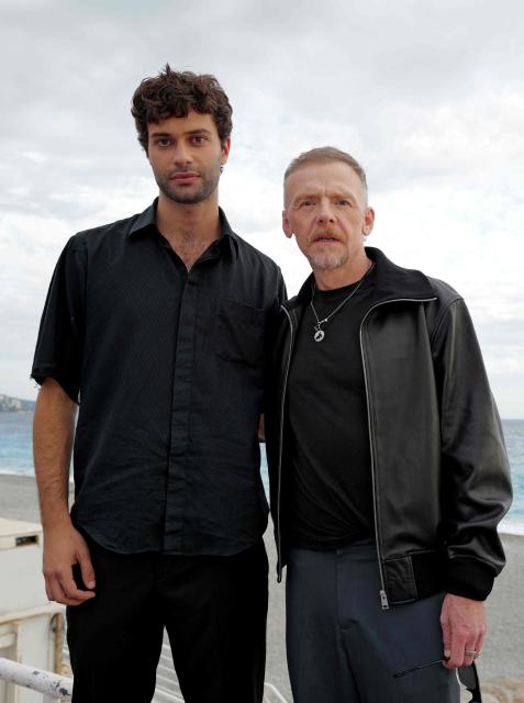 British actor Simon Pegg (R) and French actor Liam Hellmann (L) pose during a photocall  for the movie “Only What We Carry” at the Cineroman film festival in Nice, southeastern France on September 30, 2026. (Photo by Valery HACHE / AFP)