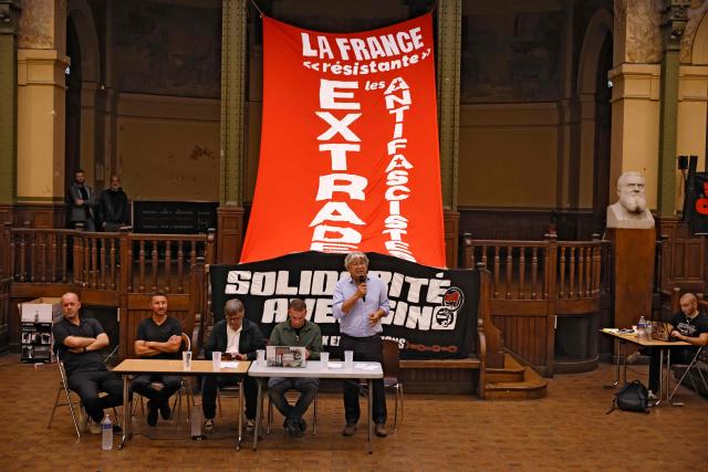 Far-left La France Insoumise (LFI) lawmaker Eric Coquerel (C) delivers a speech during a meeting against the extradition of Albanian anti-fascist activist Rexhino Abazaj, known as Gino, held at the labour exchange (Bourse du Travail) on the day France's Court of Cassation upheld his surrender to Germany, in Paris on September 30, 2026. The Paris Court of Cassation on September 30 will hear the case of "antifa" activist Rexhino Abazaj, aka Gino, who is challenging his extradition to Germany, fearing he will subsequently be handed over to Hungary in connection with the alleged attack on neo-Nazis marching in Budapest in 2023. On 19 August, the Paris Court of Appeal ordered the extradition, after France had previously refused to surrender him to Hungary over concerns for his fundamental rights. (Photo by SIMON WOHLFAHRT / AFP)