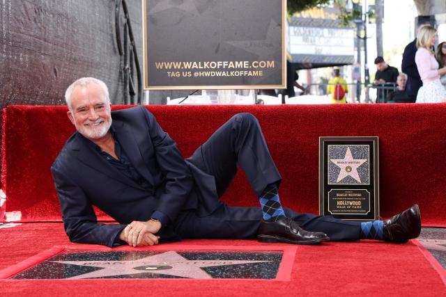 US actor Bradley Whitford lies down beside his newly unveiled Hollywood Walk of Fame star in Hollywood, California on September 30, 2026. (Photo by VALERIE MACON / AFP)