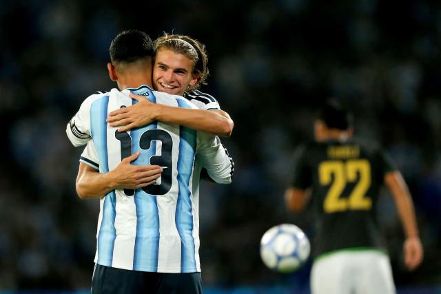 Argentina's defender #13 Cristian Romero celebrates with teammate midfielder #18 Nico Paz after scoring his team's third goal during the international friendly football match between Argentina and Bolivia at Mario Alberto Kempes Stadium in Cordoba, Argentina, on September 30, 2026. (Photo by Diego Lima / AFP)
