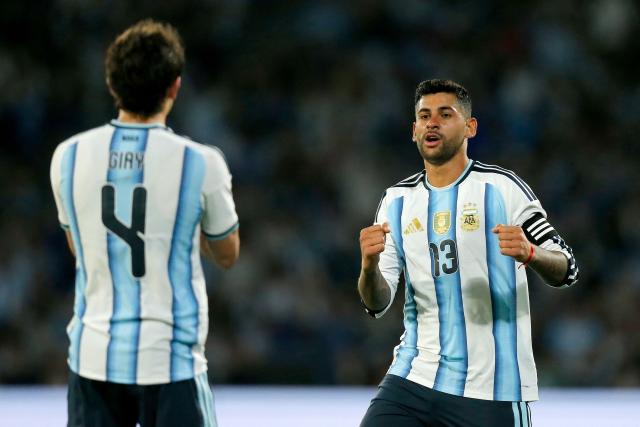 Argentina's defender #13 Cristian Romero (R) celebrates with teammate defender #04 Agustin Giay after scoring his team's third goal during the international friendly football match between Argentina and Bolivia at Mario Alberto Kempes Stadium in Cordoba, Argentina, on September 30, 2026. (Photo by Diego Lima / AFP)