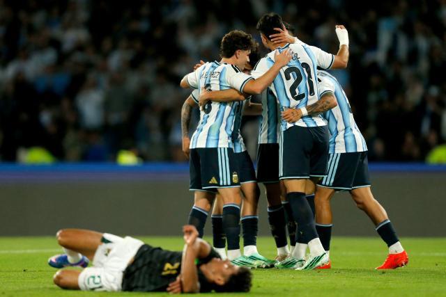 Argentina's forward #21 Jose Manuel Lopez celebrates with teammates after scoring his team's fourth goal during the international friendly football match between Argentina and Bolivia at Mario Alberto Kempes Stadium in Cordoba, Argentina, on September 30, 2026. (Photo by Diego Lima / AFP)