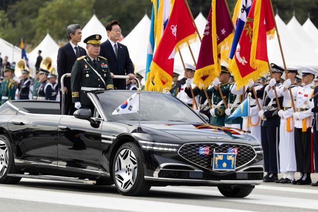 South Korean President Lee Jae Myung (C) and Defence Minister Kang Shin-chul (L) inspect military assets during the 78th Armed Forces Day at a military base in Gyeryong on October 1, 2026. (Photo by JEON HEON-KYUN / POOL / AFP)