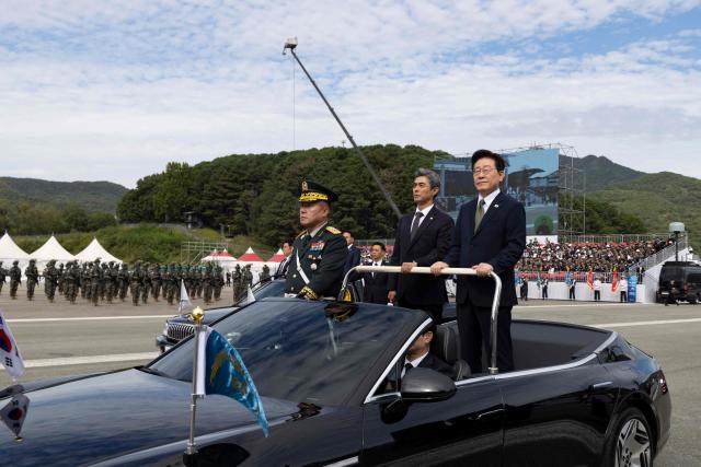 South Korean President Lee Jae Myung (R) and Defence Minister Kang Shin-chul (2nd-R) inspect military assets during the 78th Armed Forces Day at a military base in Gyeryong on October 1, 2026. (Photo by JEON HEON-KYUN / POOL / AFP)
