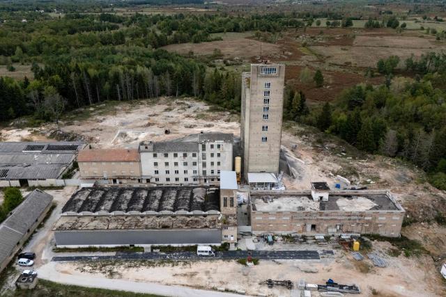 Aerial view shows the former PPK Velebit agro-food industrial complex and its silo where waste was illegally dumped and buried in Gospic, Croatia's Lika region, on September 21, 2026. As Croatia prepares to clean up tens of thousands of tonnes of hazardous waste dumped in the heart of its idyllic Lika region, locals fear years of illegal dumping may have spread into its pristine surrounds. (Photo by MARKO PERKOV / AFP)