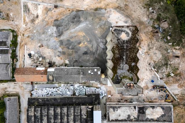 Aerial view shows the former PPK Velebit agro-food industrial complex and its silo where waste was illegally dumped and buried in Gospic, Croatia's Lika region, on September 21, 2026. As Croatia prepares to clean up tens of thousands of tonnes of hazardous waste dumped in the heart of its idyllic Lika region, locals fear years of illegal dumping may have spread into its pristine surrounds. (Photo by MARKO PERKOV / AFP)