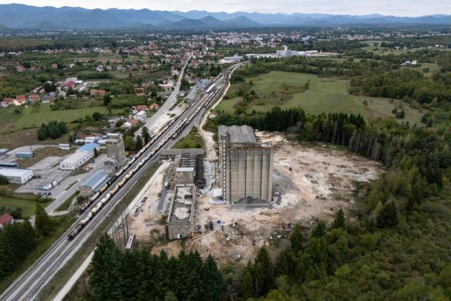 Aerial view shows the former PPK Velebit agro-food industrial complex and its silo where waste was illegally dumped and buried in Gospic, Croatia's Lika region, on September 21, 2026. As Croatia prepares to clean up tens of thousands of tonnes of hazardous waste dumped in the heart of its idyllic Lika region, locals fear years of illegal dumping may have spread into its pristine surrounds. (Photo by MARKO PERKOV / AFP)