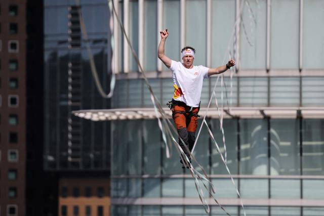 Estonia's Jaan Roose performs on a slackline during South Korea's first urban highline crossing event, 160 metres long and suspended 120 metres above the ground, in central Seoul on October 1, 2026. (Photo by KIM HONG-JI / POOL / AFP)