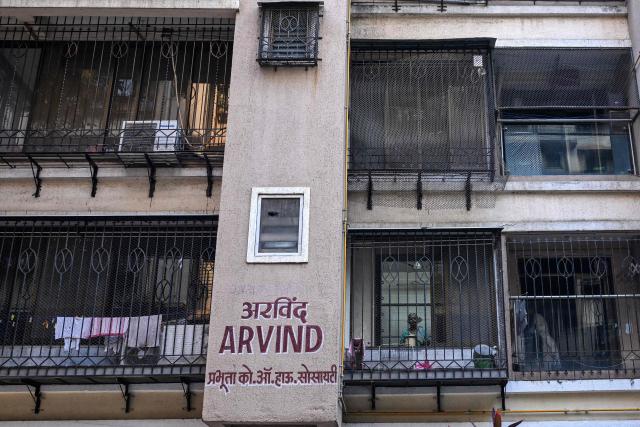 A resident looks out from the building which resides relatives of Smit Machchhar, an Indian national flydubai pilot in Mumbai on October 1, 2026. Israel's leader credited the pilot and passengers of a Dubai-Tel Aviv flight with averting catastrophe on September 30 after they overpowered a co-pilot who allegedly tried to crash the aircraft, forcing an emergency landing. (Photo by Punit PARANJPE / AFP)