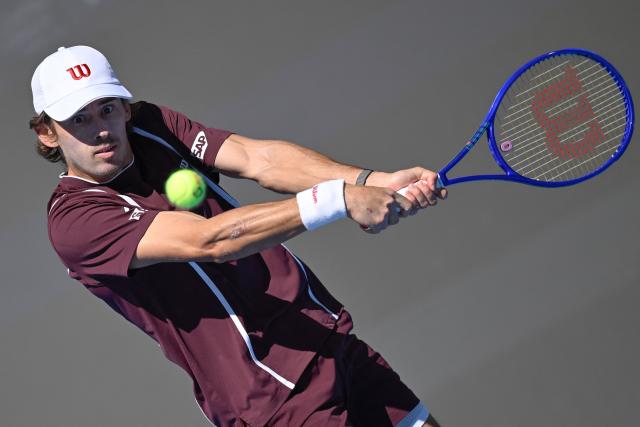Australia's Alex De Minaur hits a return to Argentina's Mariano Navone during their men's singles match at the China Open tennis tournament in Beijing on October 1, 2026. (Photo by WANG Zhao / AFP)