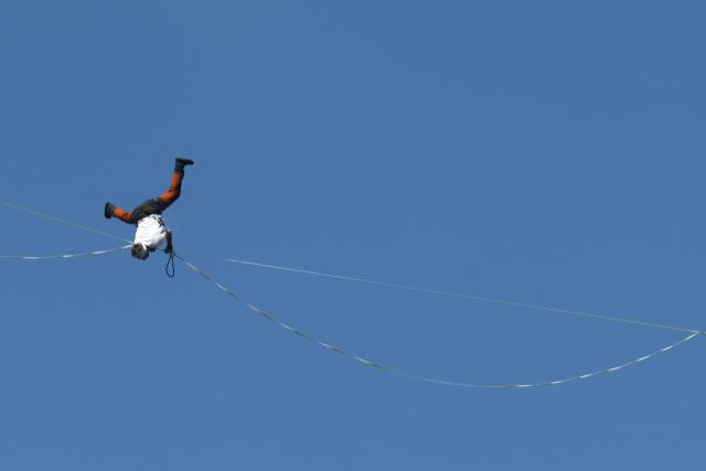 Estonia's Jaan Roose performs on a slackline during South Korea's first urban highline crossing event, 160 metres long and suspended 120 metres above the ground, in central Seoul on October 1, 2026. (Photo by Han Myung-Gu / POOL / AFP)