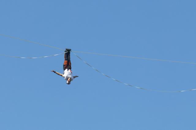 Estonia's Jaan Roose performs on a slackline during South Korea's first urban highline crossing event, 160 metres long and suspended 120 metres above the ground, in central Seoul on October 1, 2026. (Photo by Han Myung-Gu / POOL / AFP)