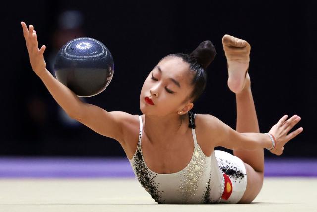 Kyrgyzstan’s Asel Arapova competes in the individual ball of the rhythmic gymnastics qualification round during the 2026 Asian Games at the Nagoya General Gymnasium in Nagoya on October 1, 2026. (Photo by DAVID GRAY / AFP)