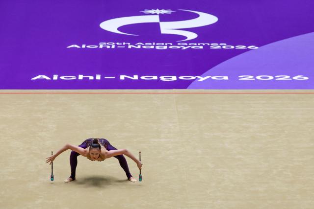 China’s Wang Zilu competes in the individual clubs of the rhythmic gymnastics qualification round during the 2026 Asian Games at the Nagoya General Gymnasium in Nagoya on October 1, 2026. (Photo by DAVID GRAY / AFP)