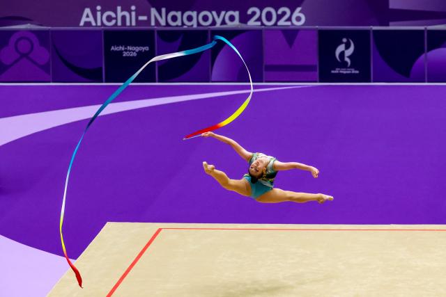 China’s Wang Zilu competes in the individual ribbon of the rhythmic gymnastics qualification round during the 2026 Asian Games at the Nagoya General Gymnasium in Nagoya on October 1, 2026. (Photo by DAVID GRAY / AFP)