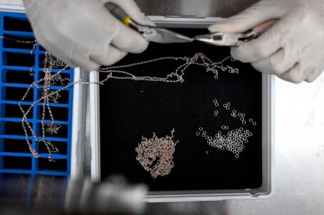 A worker crafts jewellery at Pandora's new manufacturing plant in Ho Chi Minh City on October 1, 2026, as the world's biggest jewellery brand opened the facility it said will be able to produce up to 60 million pieces each year. Danish company Pandora said the $150 million plant outside Ho Chi Minh City would create 7,000 local jobs and become the world's largest crafting facility for fine jewellery. (Photo by Nhac NGUYEN / AFP)