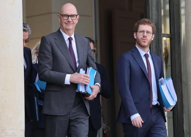 France's Economy, Finances and Industry Minister Roland Lescure (l) AND France’s junior Minister for Public Accounts David Amiel leave after the weekly cabinet meeting (Conseil des ministres) during which the 2027 state draft budget (PLF) and social security financing bill (PLFSS) for 2027 were presented, at the Elysee Palace in Paris, on October 1, 2026. (Photo by Ludovic MARIN / AFP)