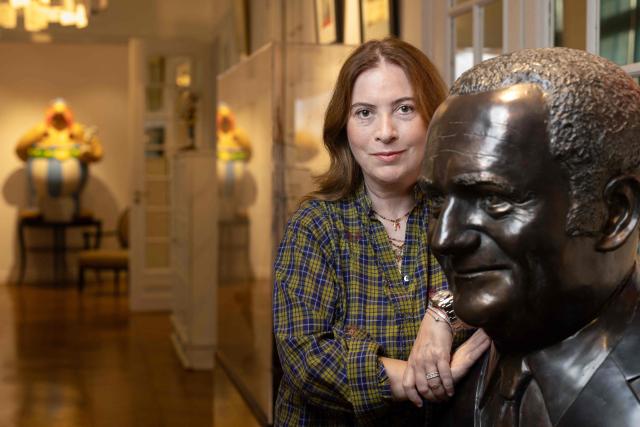 Director of IMAV Éditions Anne Goscinny poses next to the bust of her father, René Goscinny in her office in Paris, on september 30, 2026. Anne Goscinny is a  french author, screenwriter, and the sole heir and manager of the estate of her father, René Goscinny, the legendary co-creator of Astérix and Le Petit Nicolas in Paris. (Photo by JOEL SAGET / AFP)