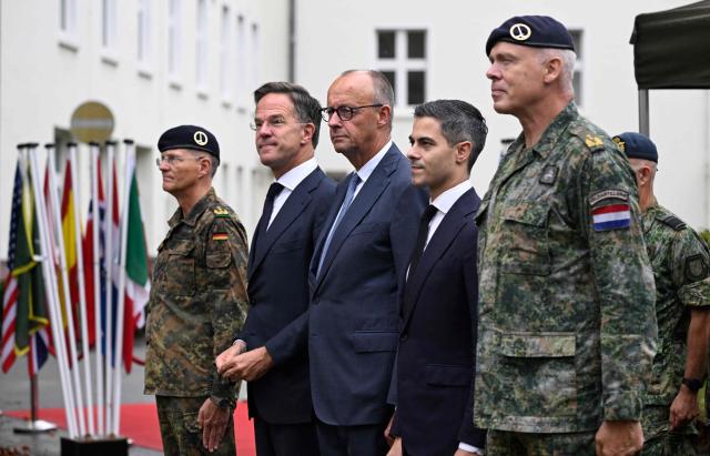 (L-R) The Lieutnant General Peter Mirow of the German armed forces (Bundeswehr), NATO Secretary General Mark Rutte, German Chancellor Friedrich Merz, the Prime Minister of the Netherlands Rob Jetten (2nd L) and Major General Wilfred Rietdijk of the Royal Netherlands Army visit the German-Netherlands Corps in Muenster, western Germany, on October 1, 2026. (Photo by INA FASSBENDER / AFP)
