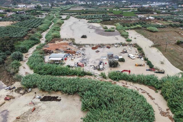 An aerial view shows the overflowing Giophyros River in Heraklion, on the island of Crete, on October 1, 2026. A man died on the Greek island of Crete amid flooding caused around the Aegean Sea by heavy rainfall and strong winds that confined many ferries to port, officials and reports said on October 1, 2026. (Photo by Costas METAXAKIS / AFP)