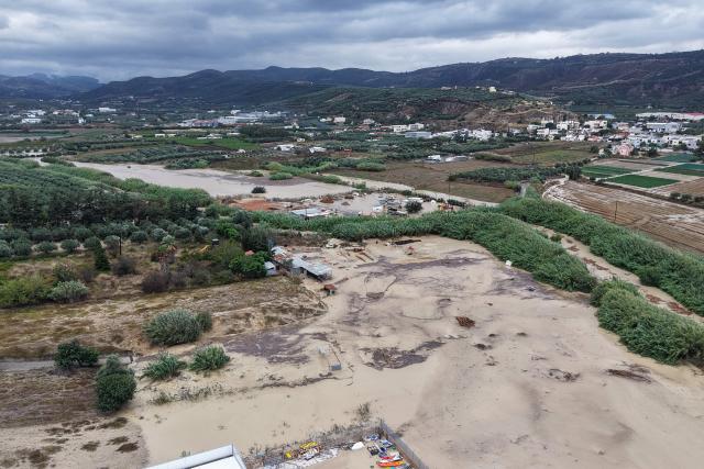 An aerial view shows the overflowing Giophyros River in Heraklion, on the island of Crete, on October 1, 2026. A man died on the Greek island of Crete amid flooding caused around the Aegean Sea by heavy rainfall and strong winds that confined many ferries to port, officials and reports said on October 1, 2026. (Photo by Costas METAXAKIS / AFP)